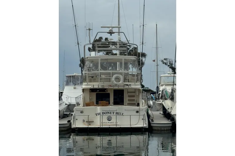 The Donut Hull Yacht Photos Pics 2002 Mikelson 50 Flybridge yacht docked at marina, rear view.