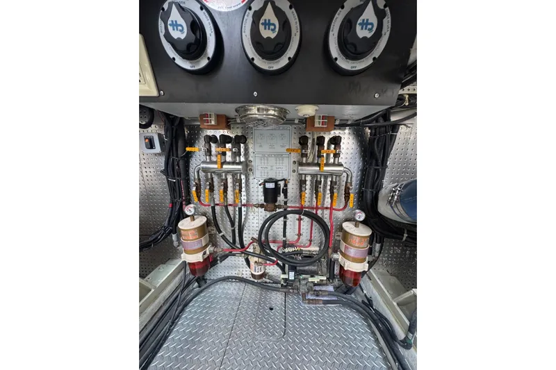 The Donut Hull Yacht Photos Pics Engine room of 2002 Mikelson 50 Flybridge with fuel system components and gauges.