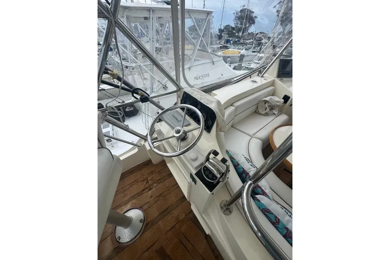 The Donut Hull Yacht Photos Pics 2002 Mikelson 50 Flybridge yacht interior with steering wheel and seating area.