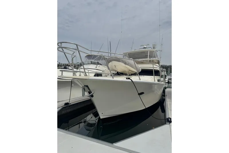 The Donut Hull Yacht Photos Pics 2002 Mikelson 50 Flybridge yacht docked at marina, front view.