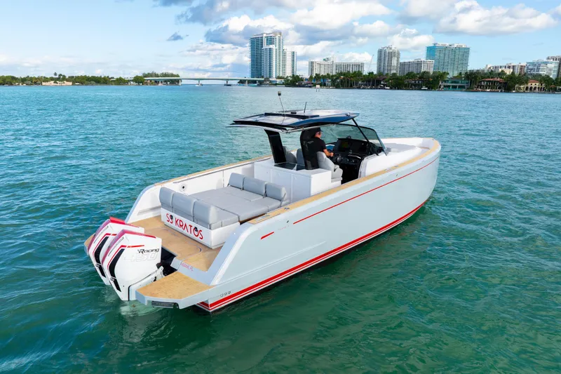  Yacht Photos Pics 2021 Pardo Yachts 38 cruising on clear blue waters near a city skyline.