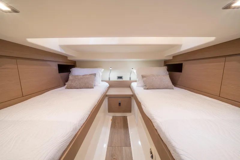  Yacht Photos Pics Luxurious twin cabin interior of 2021 Pardo Yachts 38, featuring modern wood finishes.