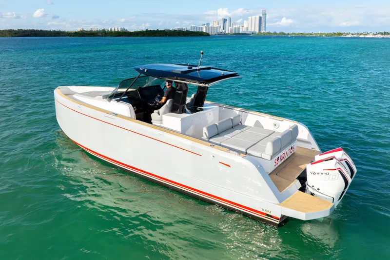  Yacht Photos Pics 2021 Pardo Yachts 38 cruising on turquoise waters near a city skyline.