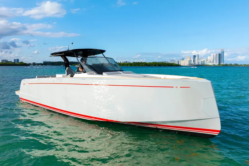  Yacht Photos Pics 2021 Pardo Yachts 38 cruising on clear blue waters near a city skyline.