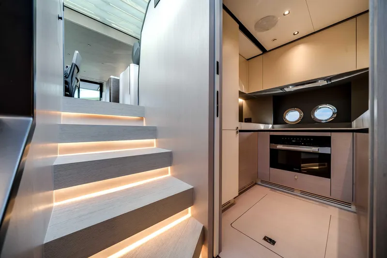  Yacht Photos Pics Luxurious interior of 2025 Azimut S8 yacht featuring modern kitchen and illuminated stairs.