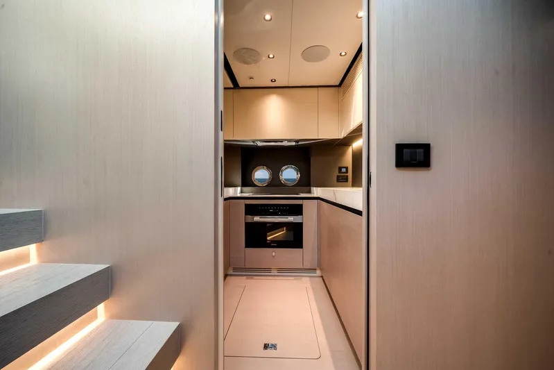  Yacht Photos Pics Modern kitchen interior of 2025 Azimut S8 yacht with sleek design and porthole window.