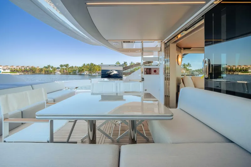  Yacht Photos Pics Luxurious 2025 Azimut S8 yacht deck with elegant seating and scenic waterfront view.