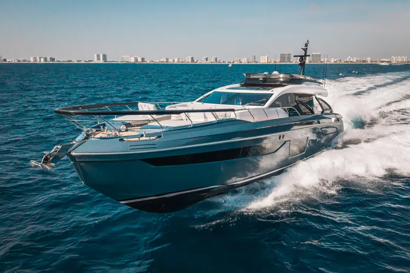  Yacht Photos Pics 2025 Azimut S8 yacht cruising on open sea with city skyline in background.