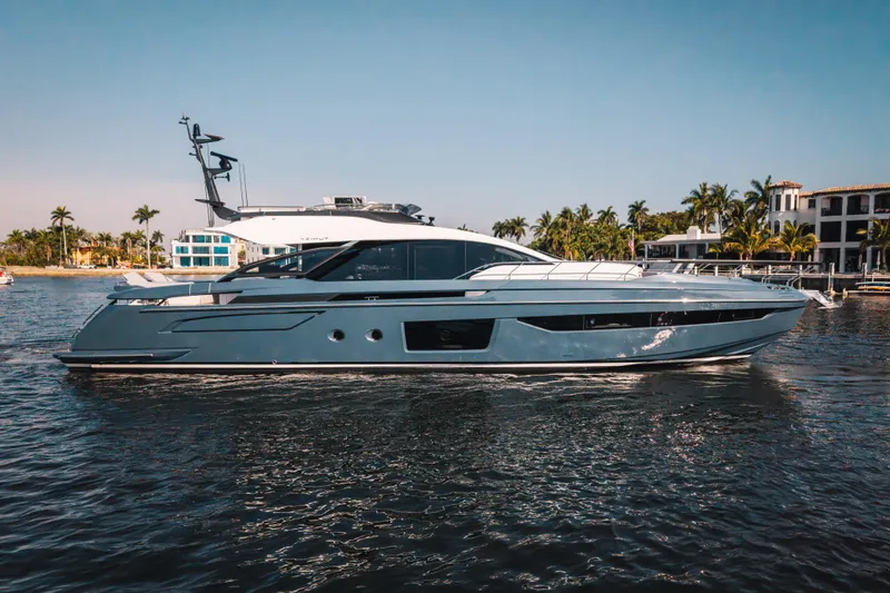  Yacht Photos Pics 2025 Azimut S8 yacht cruising on a sunny day near luxury waterfront homes.