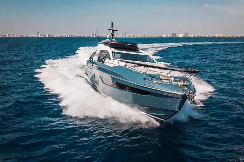  Yacht Photos Pics 2025 Azimut S8 yacht cruising on open sea with city skyline in background.