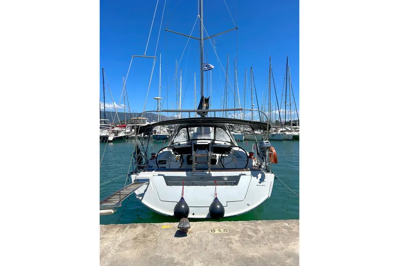  Yacht Photos Pics Beneteau Oceanis 48 sailboat, 2015 model, docked in a marina under clear blue skies.