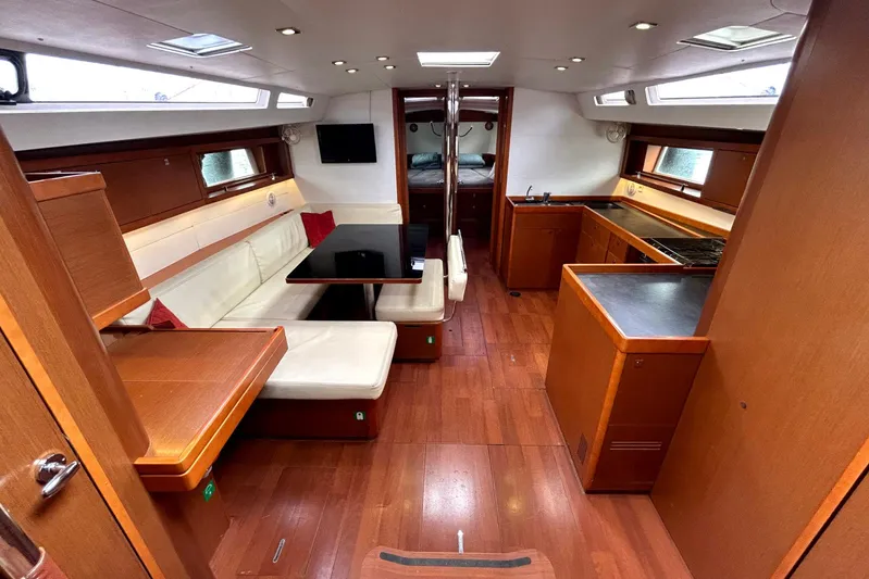 Yacht Photos Pics Luxurious interior of 2015 Beneteau Oceanis 48 yacht with wood finish and modern amenities.
