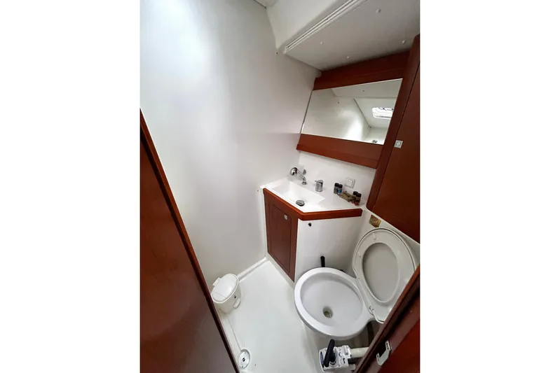  Yacht Photos Pics 2015 Beneteau Oceanis 48 yacht bathroom with sink, mirror, and toilet.