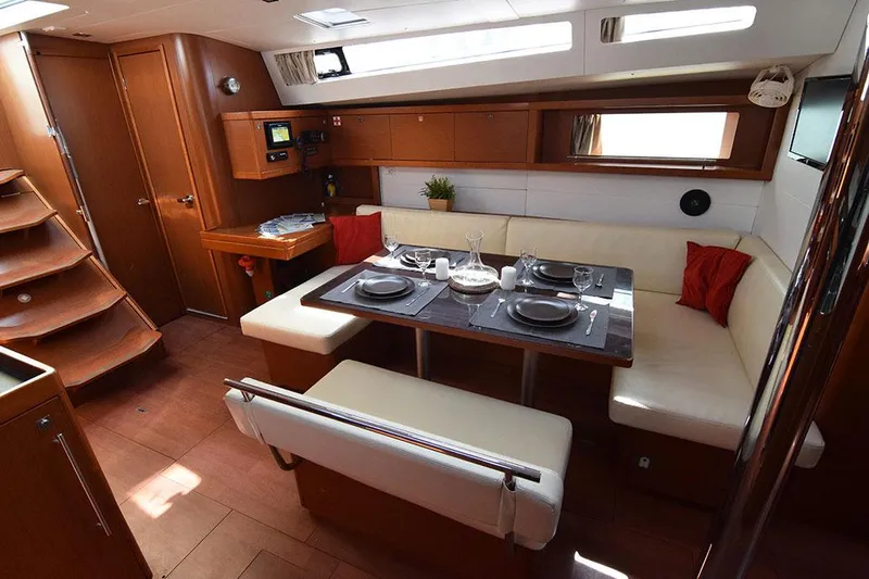  Yacht Photos Pics Luxurious interior of 2015 Beneteau Oceanis 48 yacht with elegant dining area.