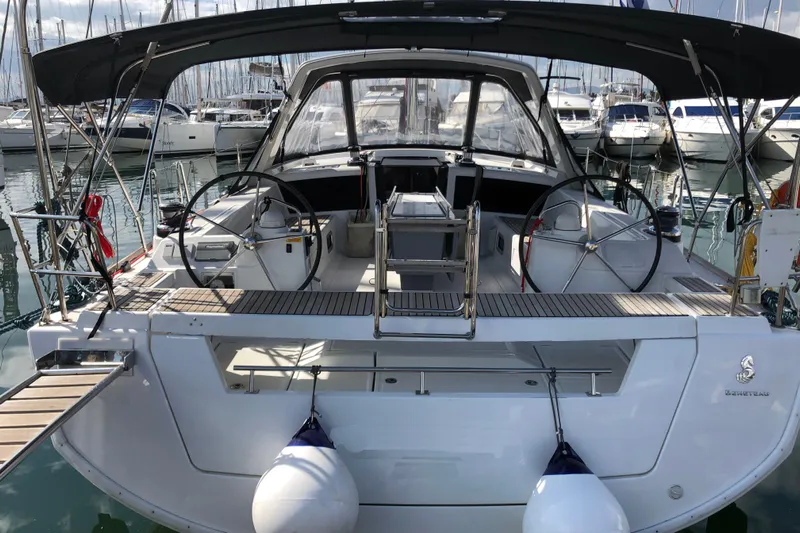  Yacht Photos Pics 2015 Beneteau Oceanis 48 yacht docked at marina, featuring dual steering wheels.