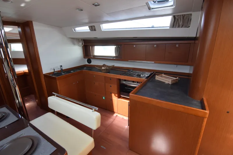  Yacht Photos Pics Luxurious interior of 2015 Beneteau Oceanis 48 yacht with modern kitchen and dining area.