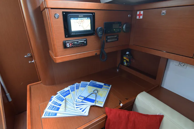  Yacht Photos Pics Navigation station on 2015 Beneteau Oceanis 48 yacht with maps and communication equipment.
