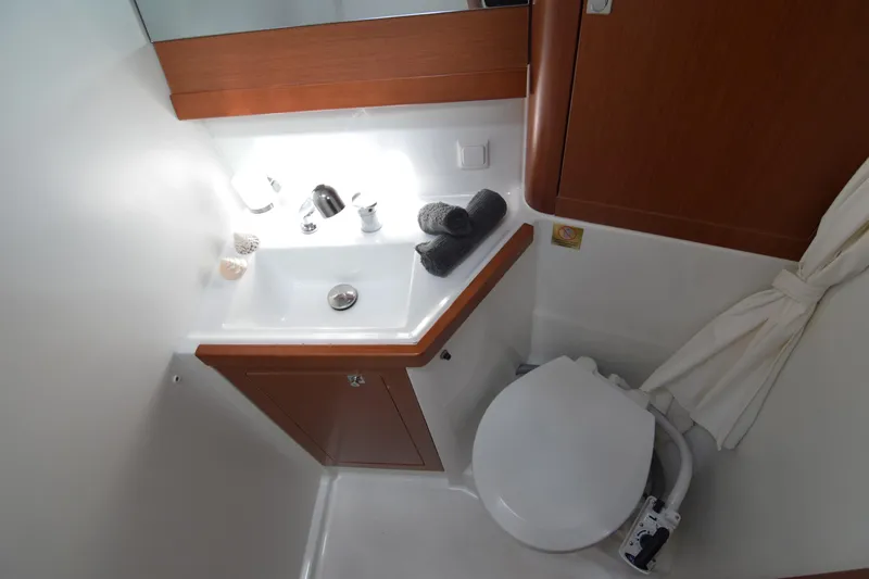  Yacht Photos Pics Bathroom interior of 2015 Beneteau Oceanis 48 yacht, featuring sink and toilet.