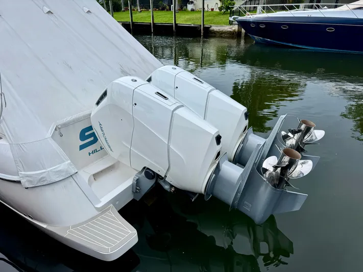  Yacht Photos Pics 2023 Intrepid 438 Evolution boat with dual Mercury outboard engines docked in calm water.