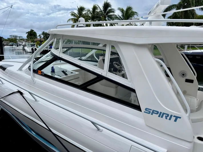  Yacht Photos Pics 2023 Intrepid 438 Evolution boat docked, featuring sleek design and "Spirit" branding.