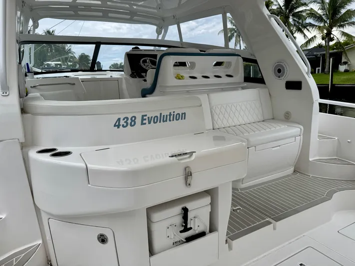  Yacht Photos Pics 2023 Intrepid 438 Evolution boat interior with seating and helm, featuring sleek design elements.