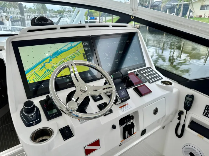  Yacht Photos Pics Helm of 2023 Intrepid 438 Evolution boat with advanced navigation displays and controls.