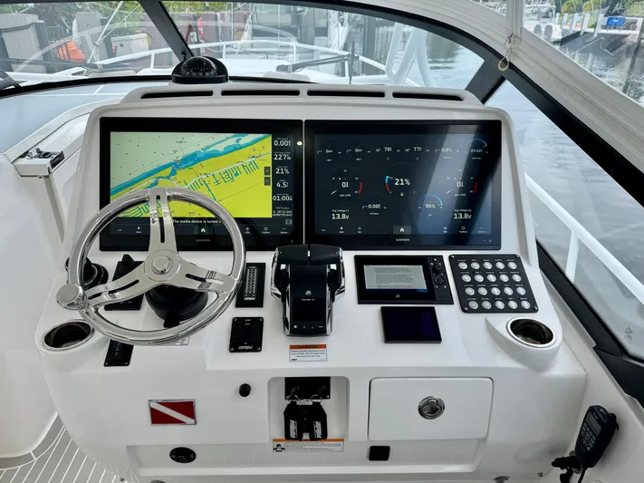  Yacht Photos Pics 2023 Intrepid 438 Evolution helm with dual displays and modern controls.
