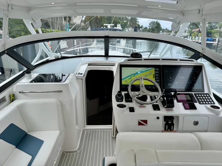  Yacht Photos Pics 2023 Intrepid 438 Evolution yacht cockpit with modern navigation system and luxurious seating.