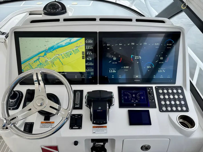  Yacht Photos Pics Helm of 2023 Intrepid 438 Evolution with dual Garmin displays and modern controls.