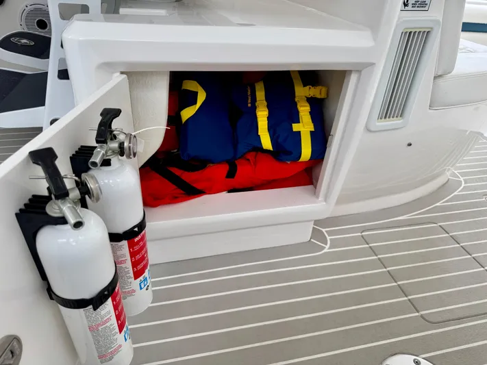  Yacht Photos Pics 2023 Intrepid 438 Evolution boat storage with life jackets and fire extinguishers.