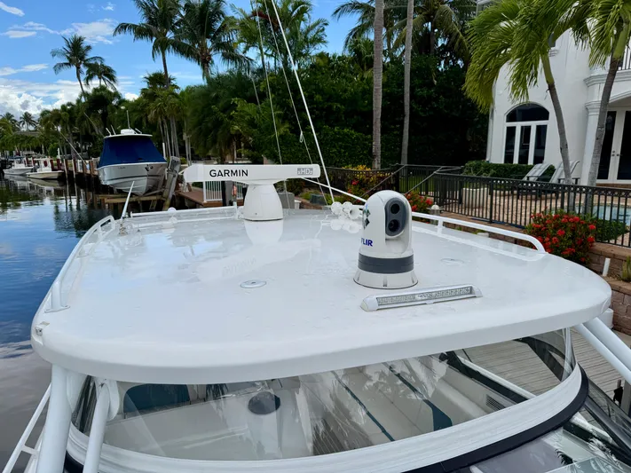  Yacht Photos Pics 2023 Intrepid 438 Evolution boat with Garmin and FLIR equipment, docked near palm trees.