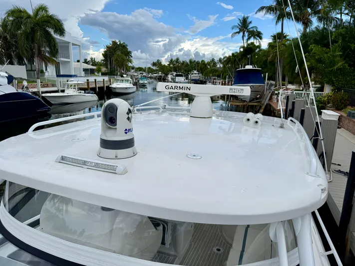  Yacht Photos Pics 2023 Intrepid 438 Evolution yacht with Garmin radar, docked in a scenic marina.