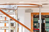 Interior of 1986 Motor Yacht 38m Nicolini, featuring elegant spiral staircase and modern design elements.