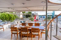 Luxurious deck of 1986 Motor Yacht 38m Nicolini with elegant dining area and scenic views.