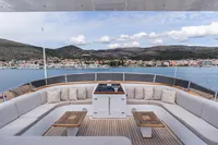 Luxurious 1986 Motor Yacht 38m Nicolini deck with scenic coastal view.
