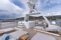 Luxurious deck of 1986 Motor Yacht 38m Nicolini with sun loungers and scenic views.