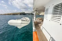 38m Nicolini Motor Yacht (1986) with tender, docked in scenic coastal waters.