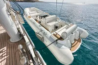 Luxury yacht with tender boat on deck, 38m Nicolini, 1986 model, ocean backdrop.