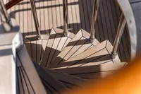 Spiral staircase on 1986 Motor Yacht 38m Nicolini, featuring wooden steps and metal railings.