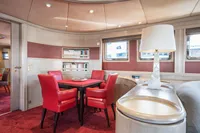 Luxurious interior of 1986 Motor Yacht 38m Nicolini with red chairs and elegant decor.