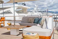 Luxurious outdoor seating on 1986 Motor Yacht 38m Nicolini, featuring elegant cushions and table.
