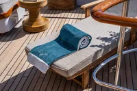 Sunbed with teal towel on 1986 Motor Yacht 38m Nicolini deck.