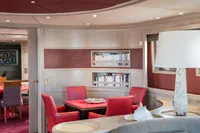 Luxurious interior of 1986 Motor Yacht 38m Nicolini with elegant red seating and bookshelves.
