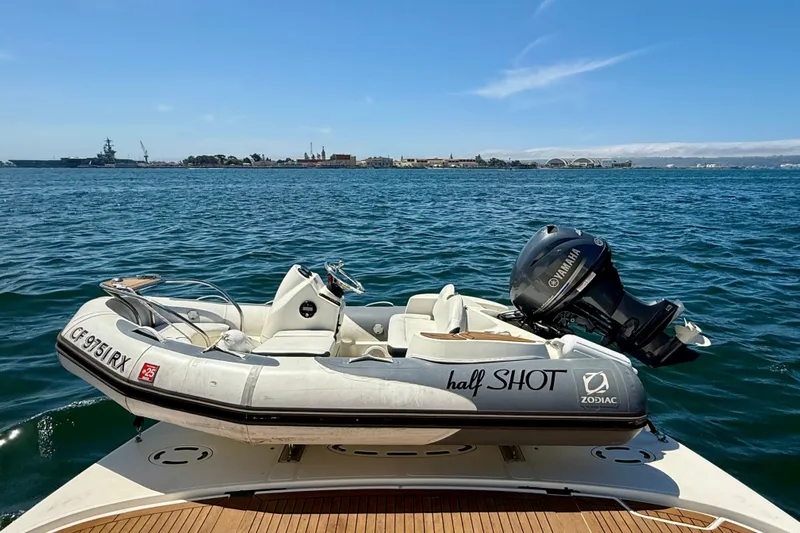 One Shot Yacht Photos Pics 2007 Sea Ray 52 Sedan Bridge with Zodiac tender and Yamaha motor on open water.