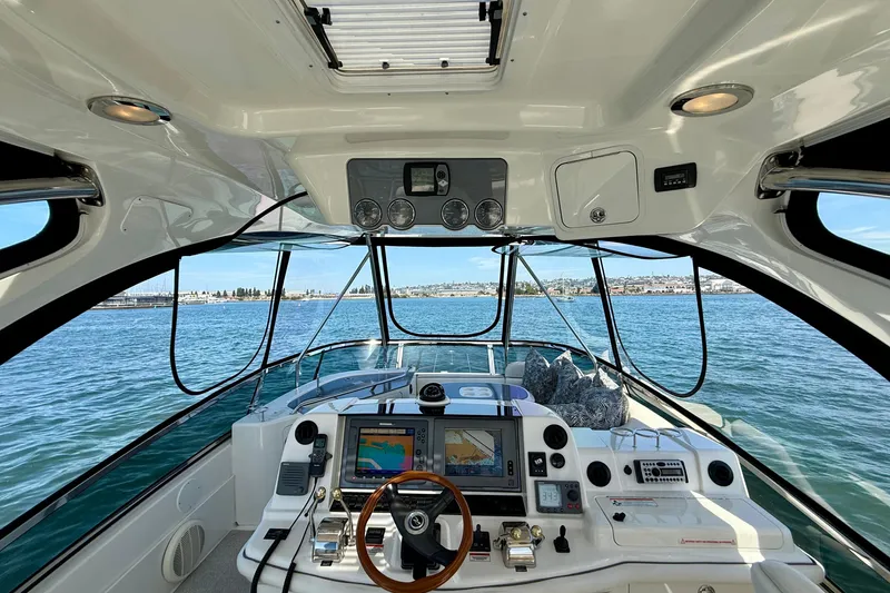One Shot Yacht Photos Pics 2007 Sea Ray 52 Sedan Bridge helm with navigation equipment and ocean view.