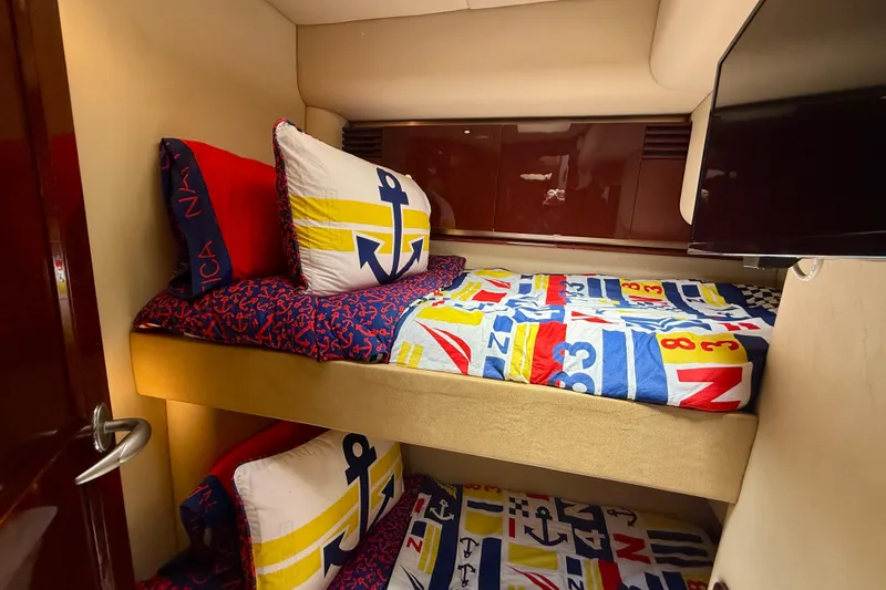 One Shot Yacht Photos Pics Bunk beds with nautical-themed bedding in 2007 Sea Ray 52 Sedan Bridge yacht cabin.
