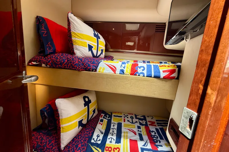 One Shot Yacht Photos Pics Bunk beds with nautical-themed bedding in 2007 Sea Ray 52 Sedan Bridge yacht cabin.