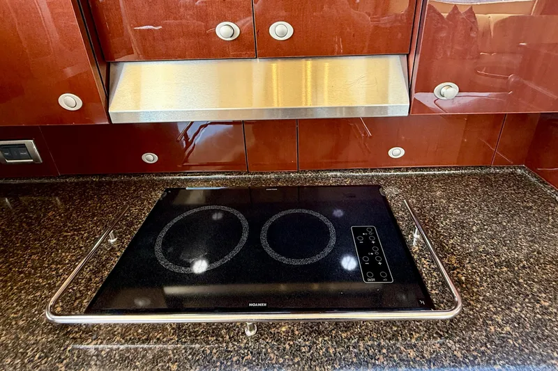 One Shot Yacht Photos Pics Luxury yacht kitchen with sleek cooktop and polished wood cabinetry, Sea Ray 52 Sedan Bridge 2007.