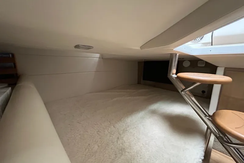Sand Piper Yacht Photos Pics 2017 Formula 350 Crossover Bowrider cabin interior with cozy bedding and wooden steps.