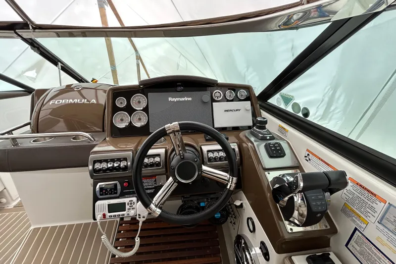 Sand Piper Yacht Photos Pics 2017 Formula 350 Crossover Bowrider dashboard with steering wheel and navigation controls.